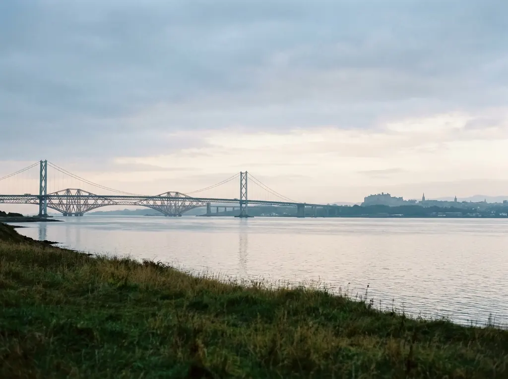 The Forth Bridges crossing the Firth of Forth from Fife toward Edinburgh.